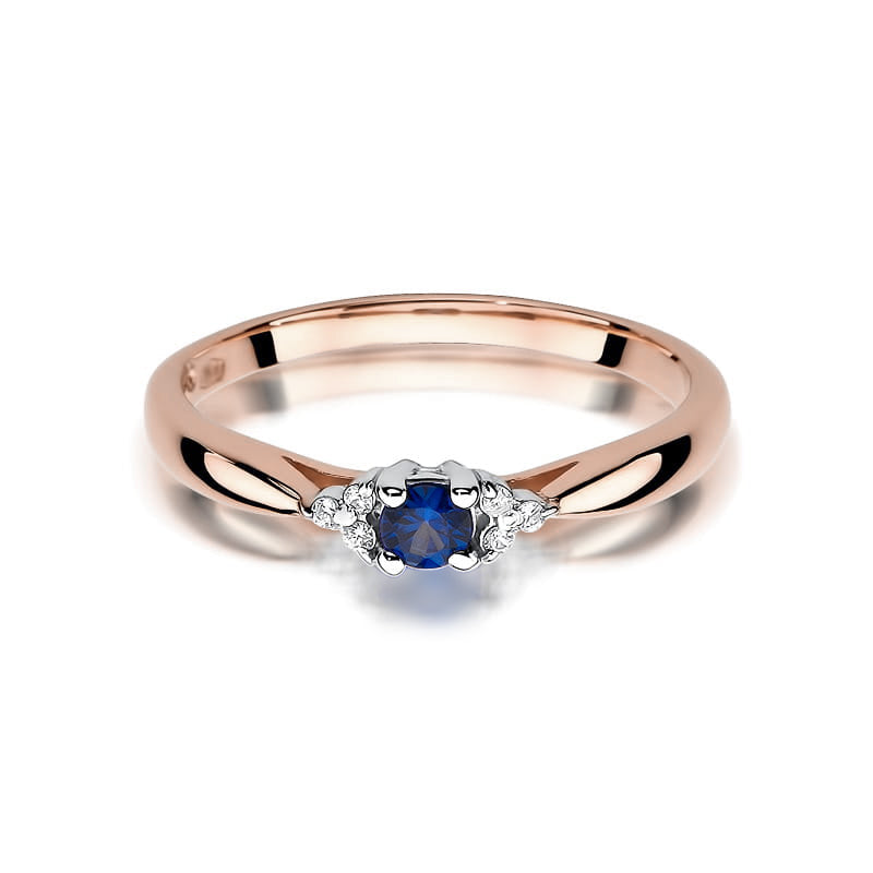 Ein Verlobungsring aus 585er Roségold mit einem runden Saphir und 6 Diamanten. Der Ring ist von der Seite fotografiert und zeigt das glänzende Roségoldband.